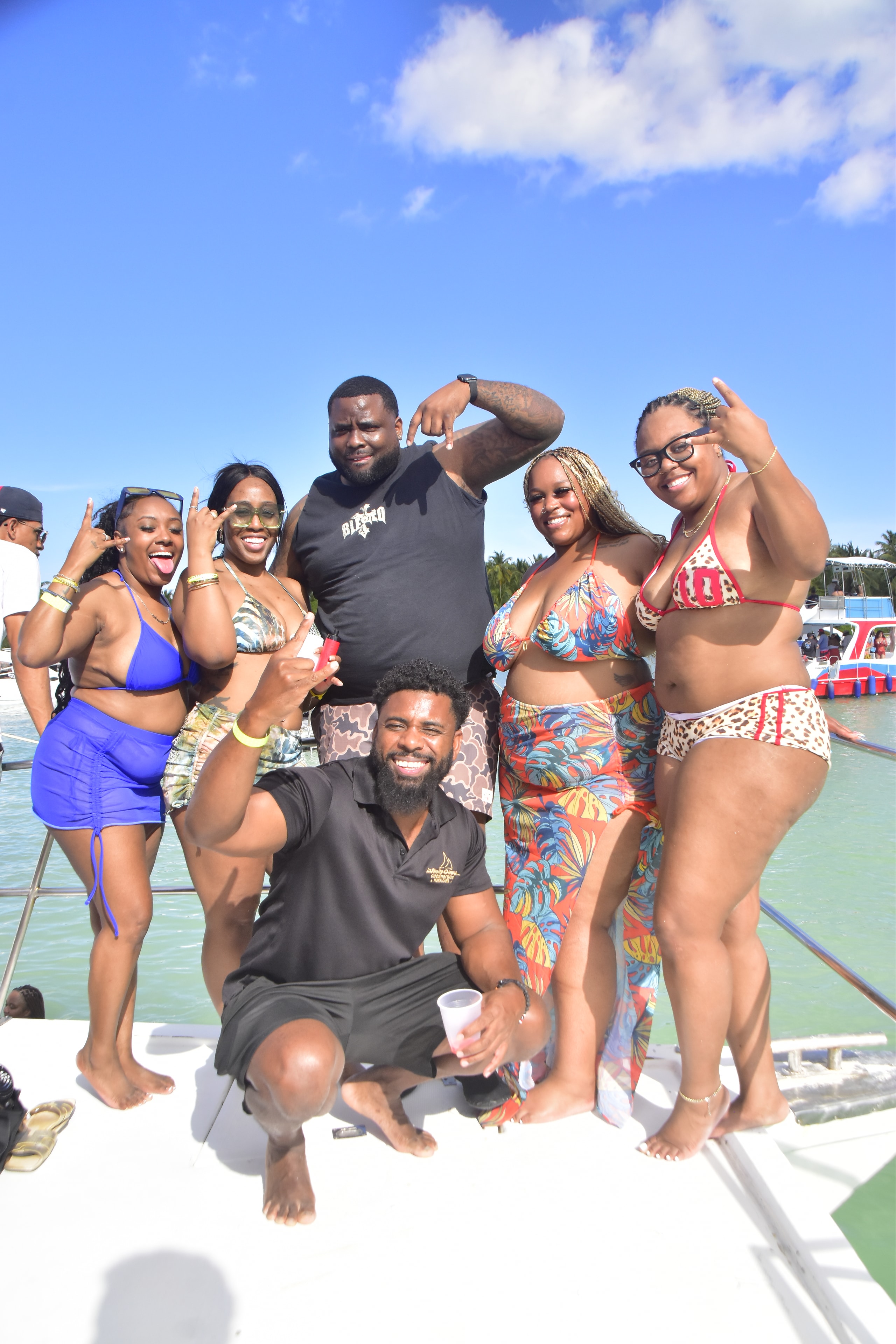 Group of friends posing together on the party boat